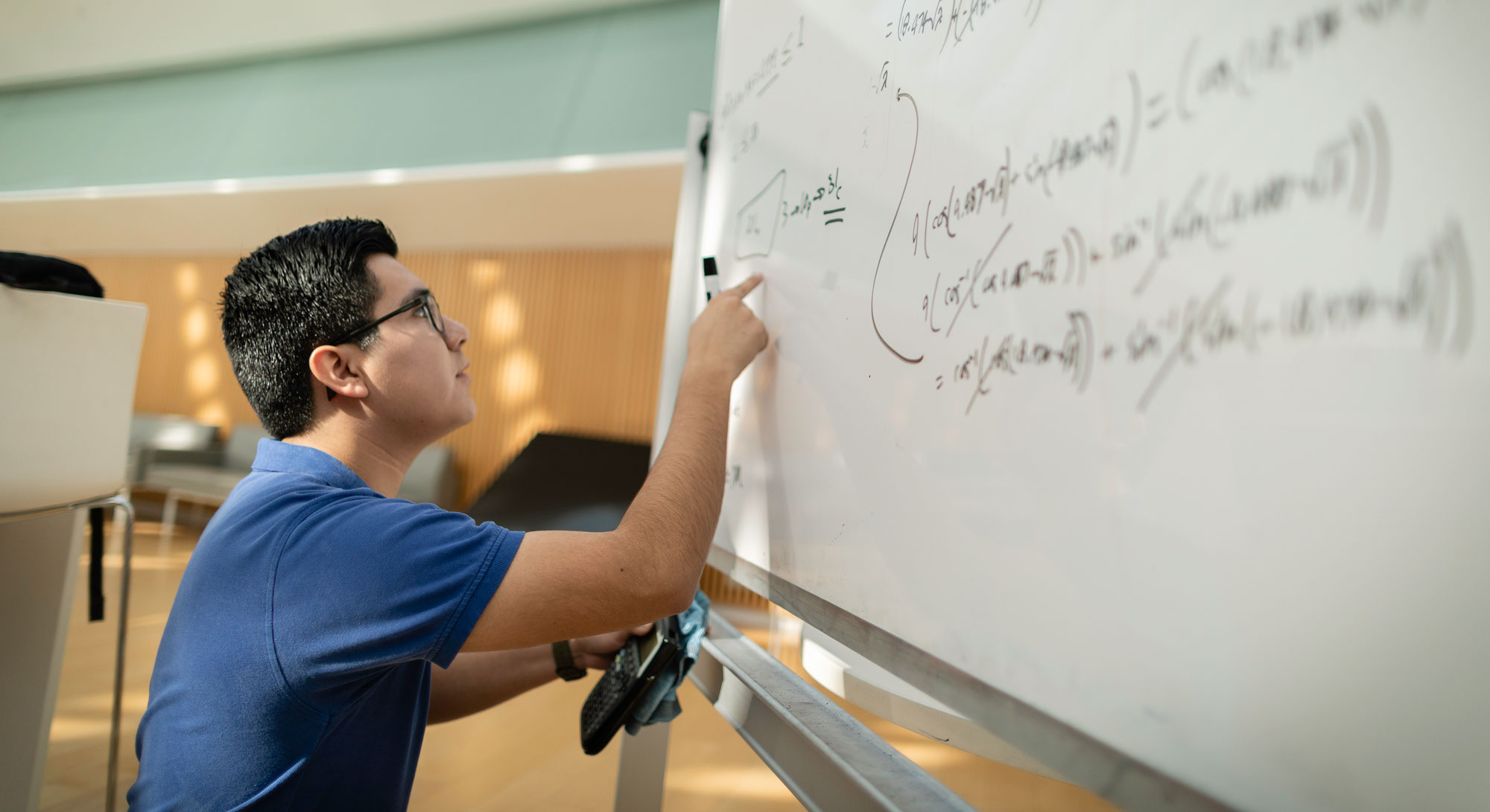 student doing math on board