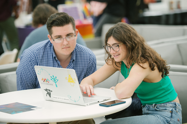 Students looking at computer. 