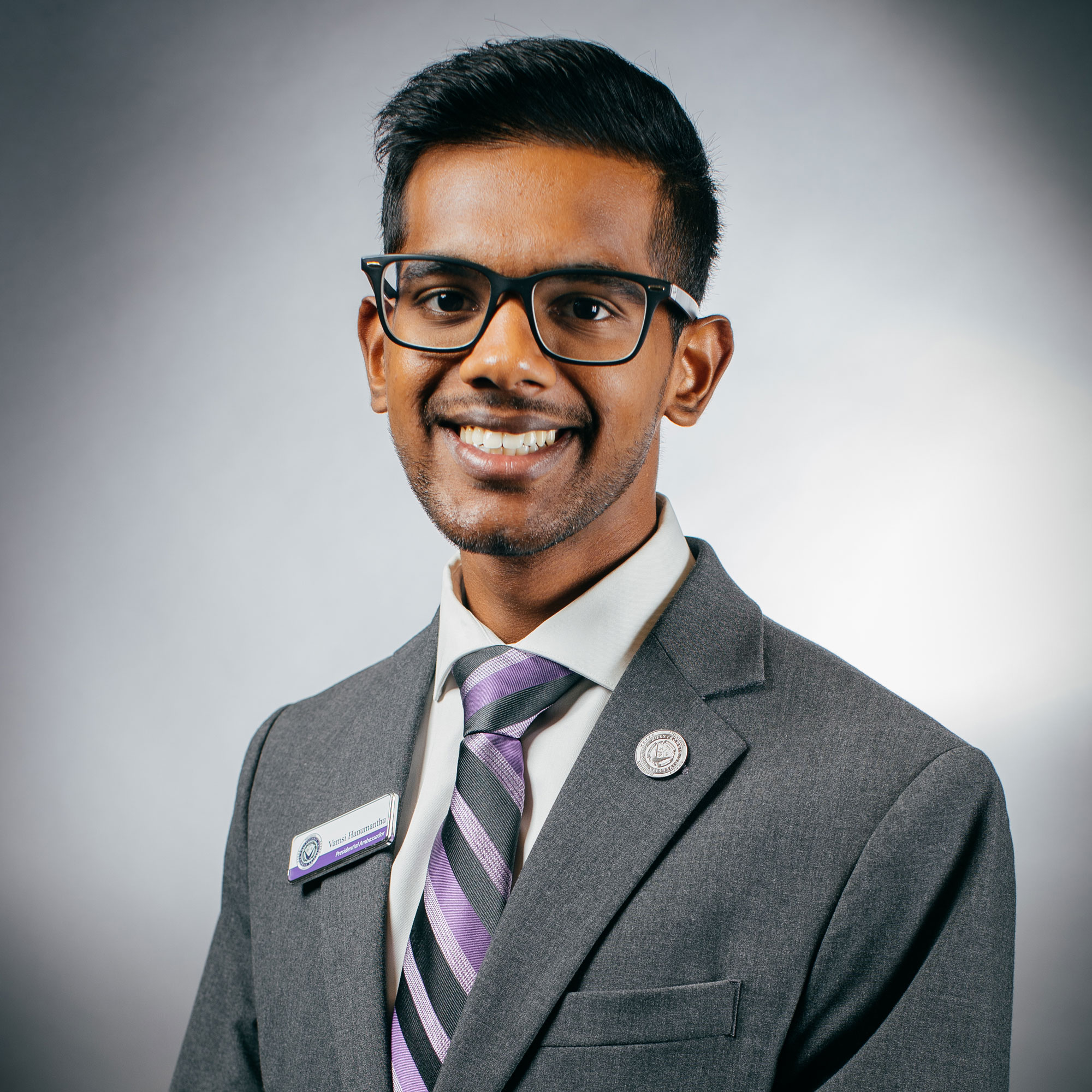 Dark skinned male with glasses.