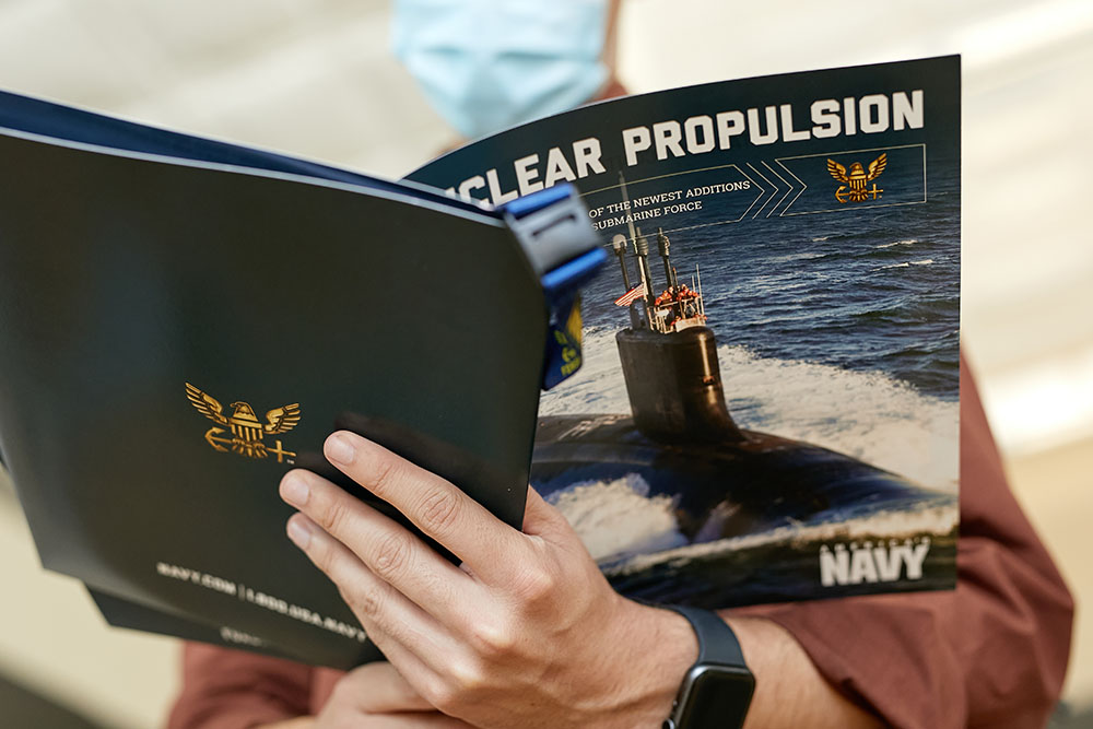 student looks at nuclear propulsion brochure