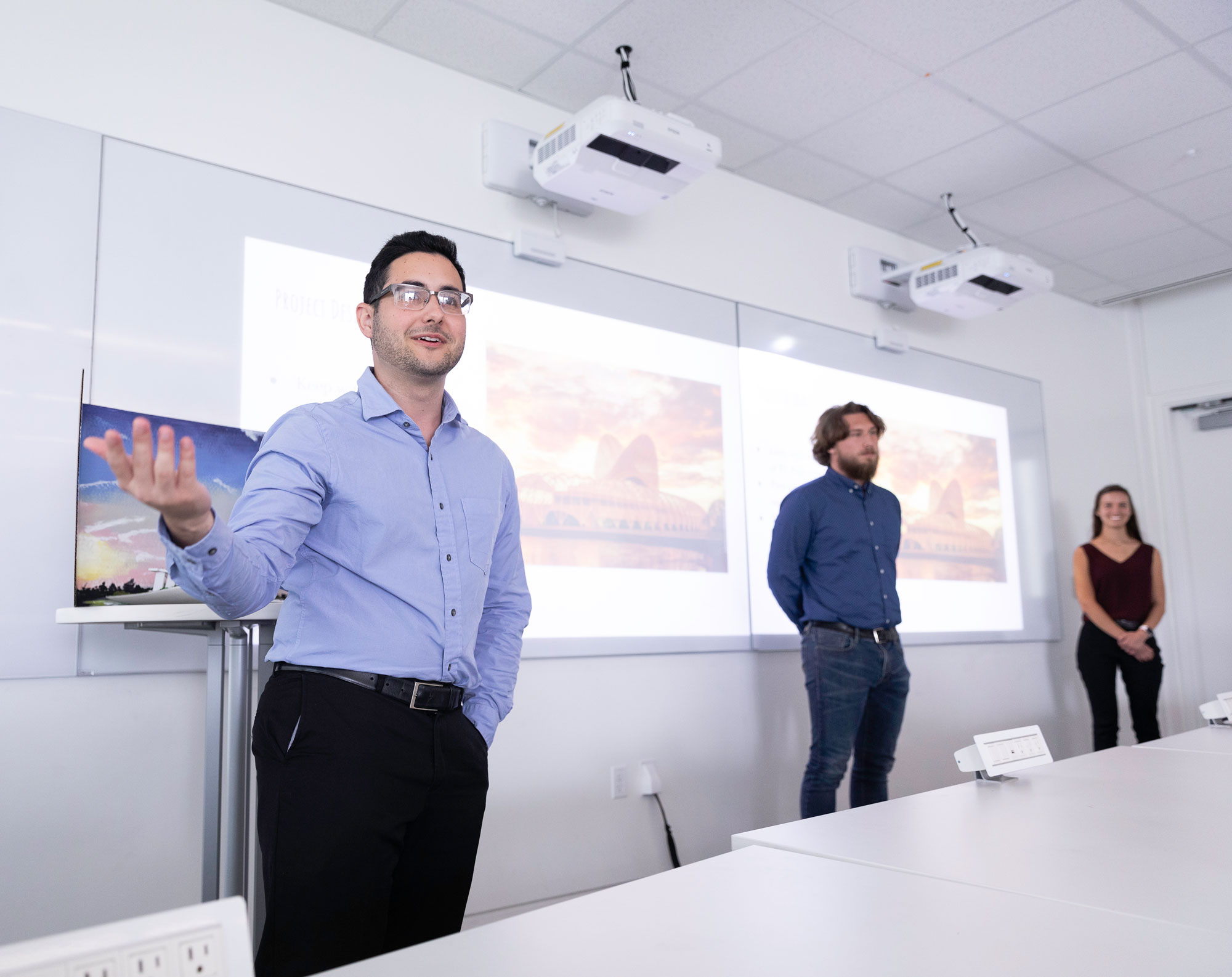 Students presenting infront of a crowd.